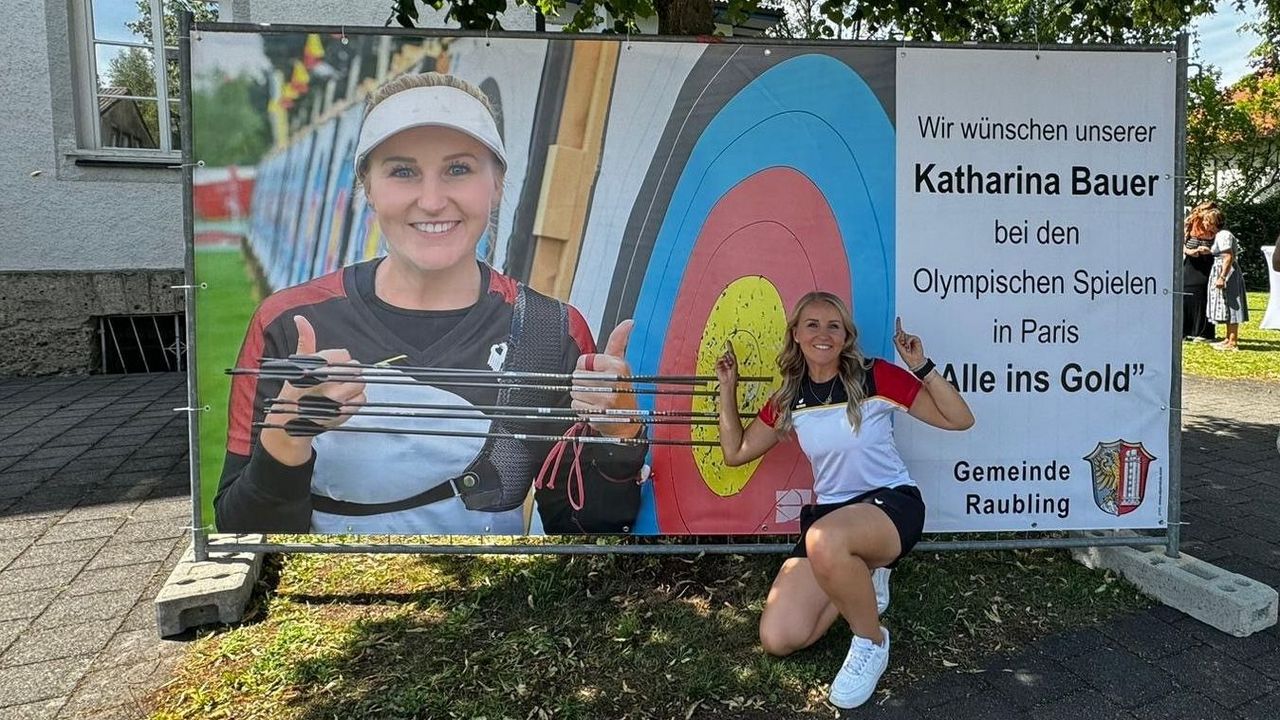 Foto: privat / Katharina Bauer vor einem der großen Banner, die die Gemeinde Raubling und ihr Verein für sie produziert haben.